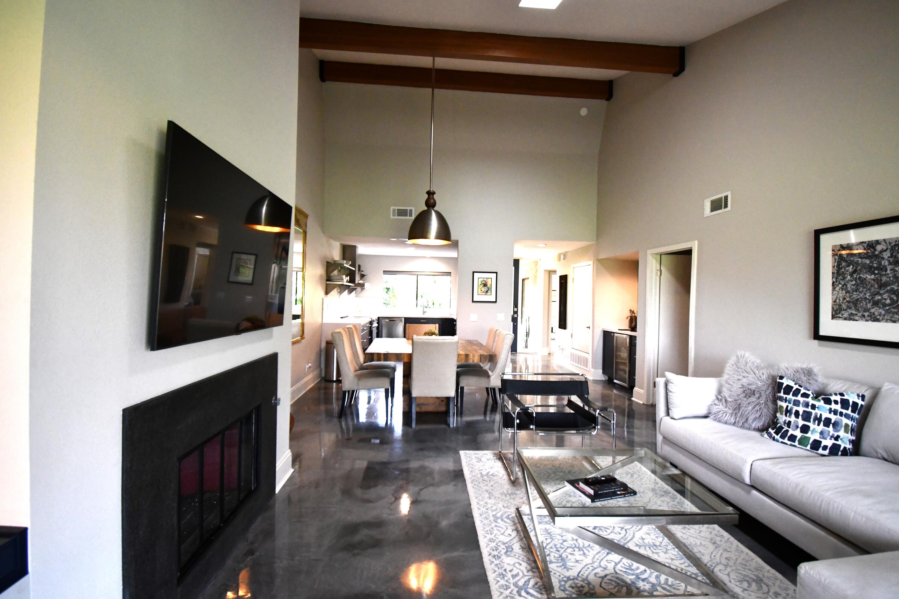 a living room with furniture a flat screen tv and a fireplace