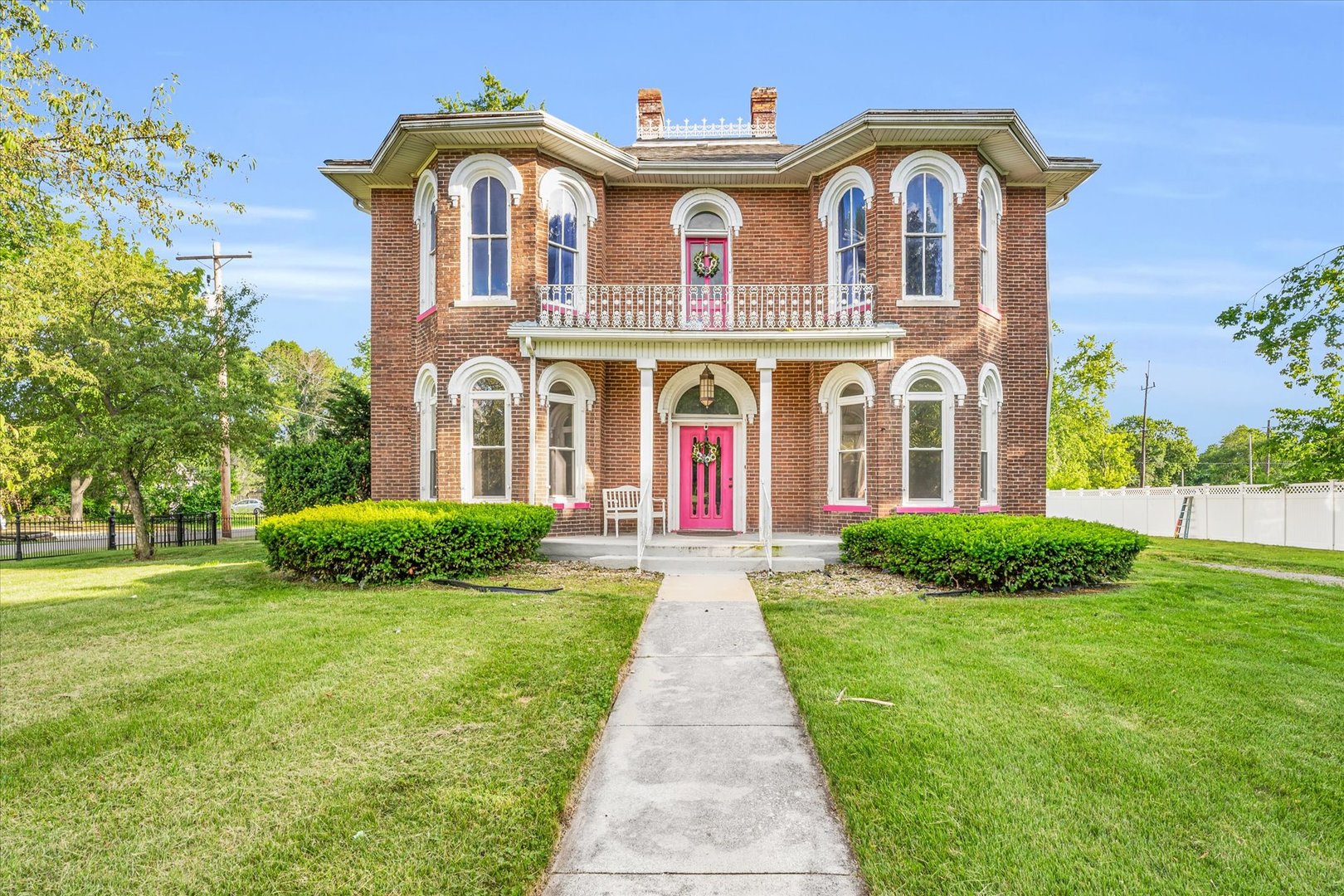 a front view of a house with a garden