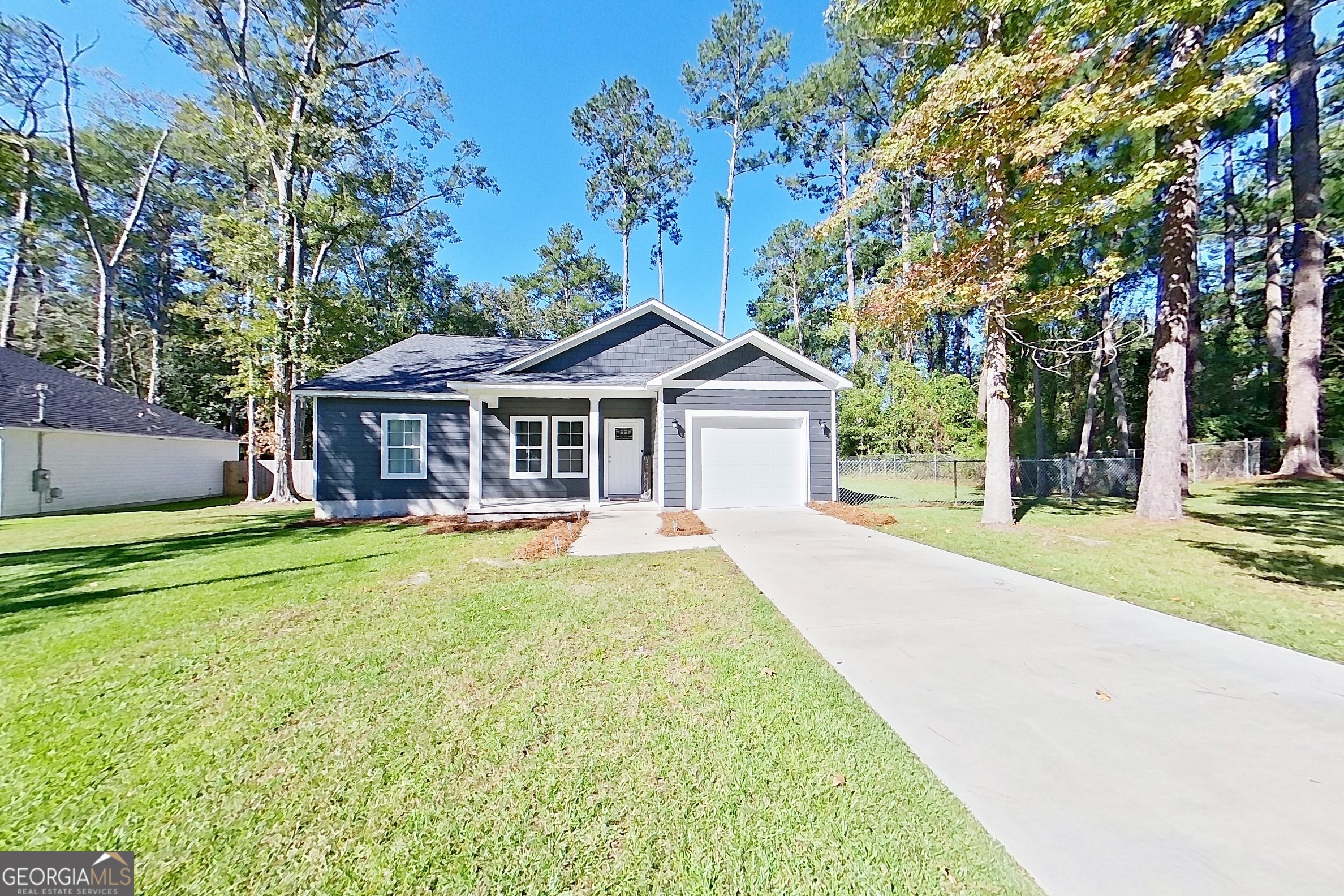 a front view of house with yard and green space