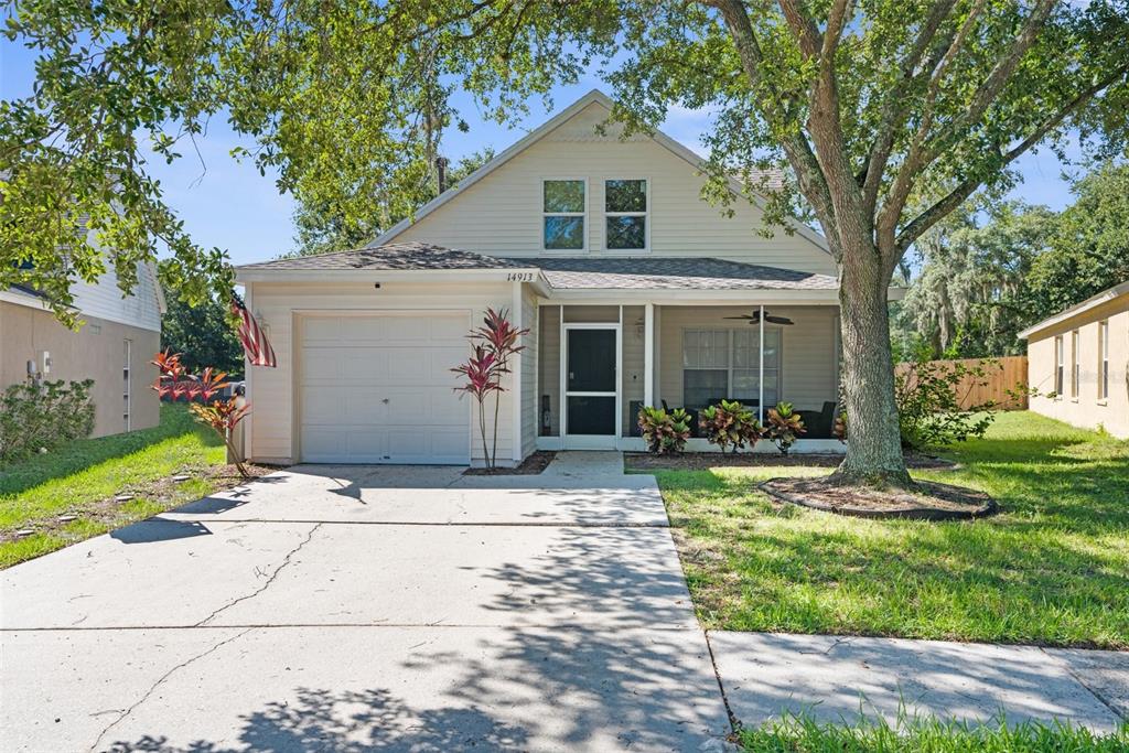 a front view of a house with yard and green space