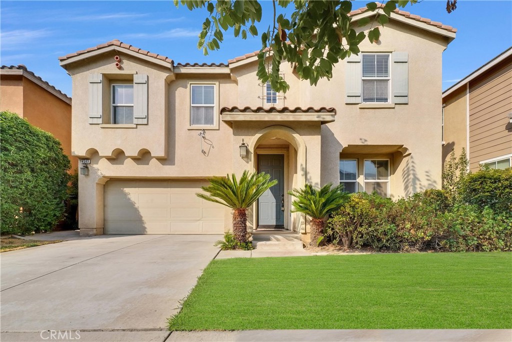 a front view of a house with a yard and garage