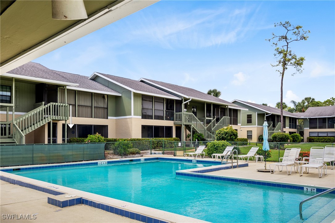 a front view of a house with swimming pool having outdoor seating