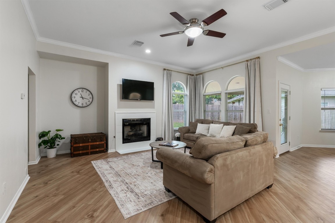 a living room with furniture a fireplace and a flat screen tv