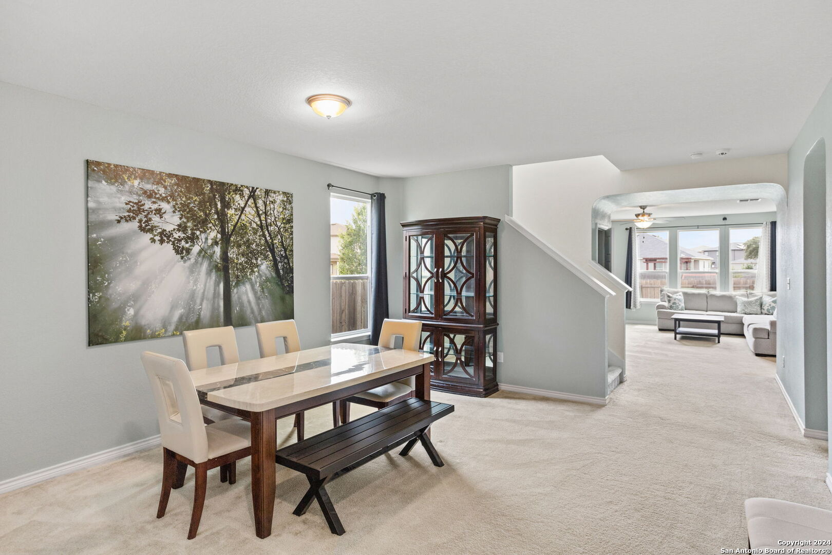 a dining room with furniture and window