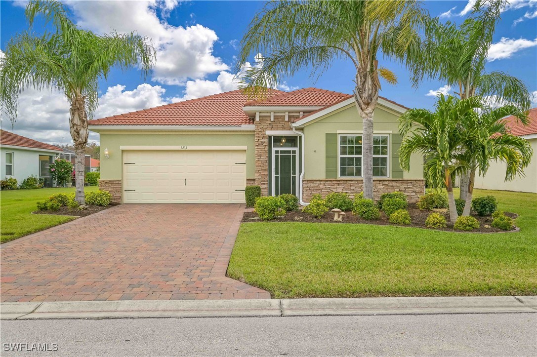 a front view of a house with a garden and patio