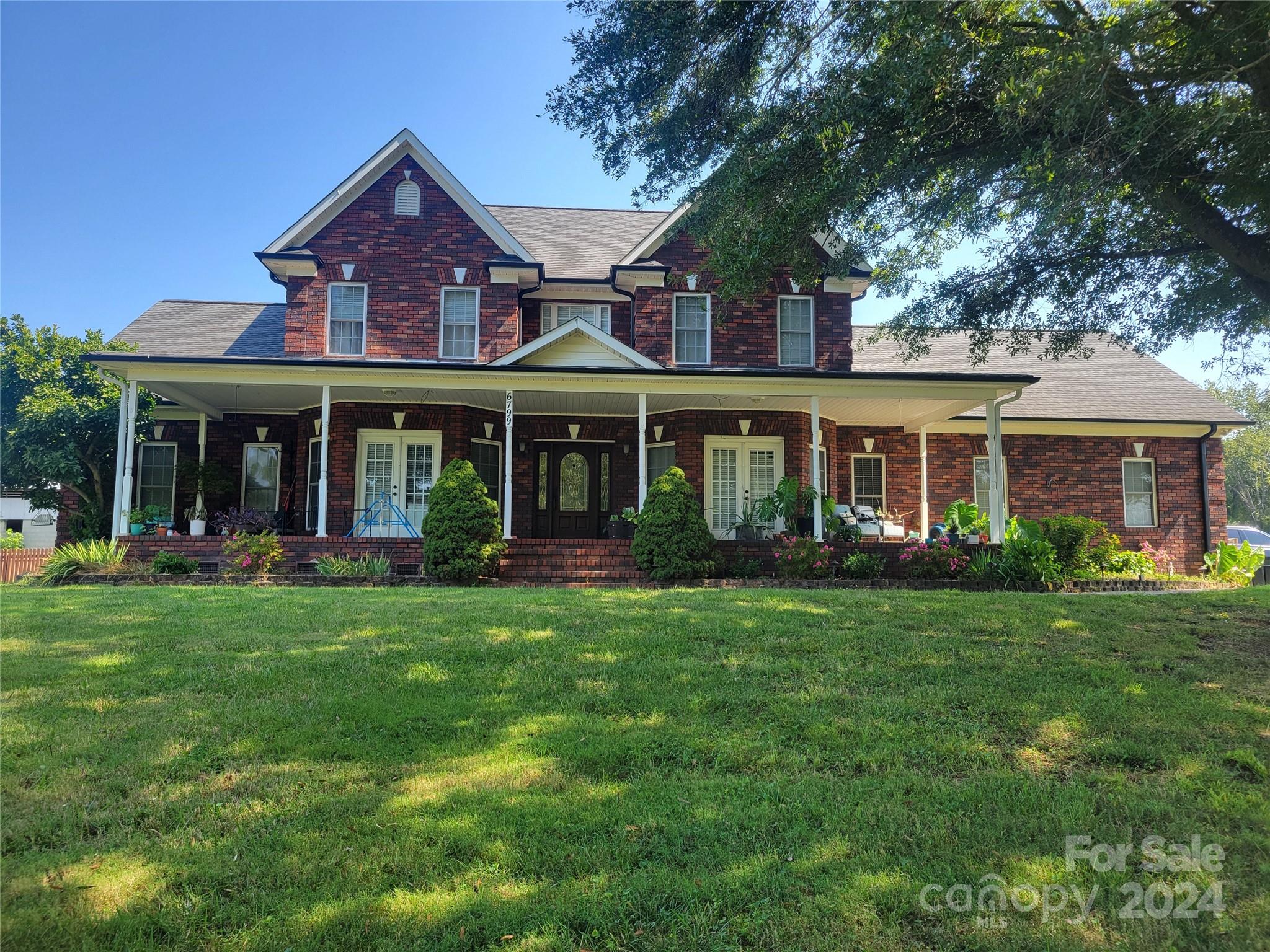 front view of a brick house with a yard