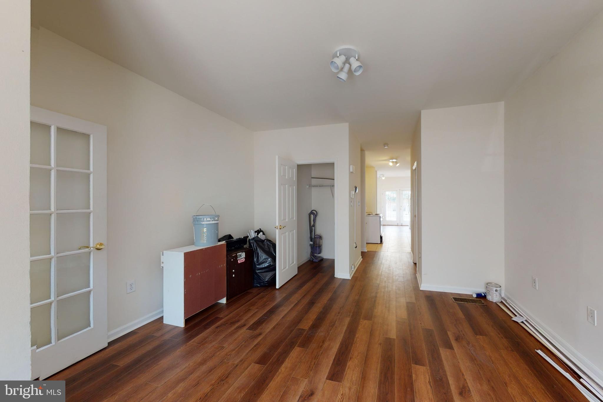 a view of a room with wooden floor and closet