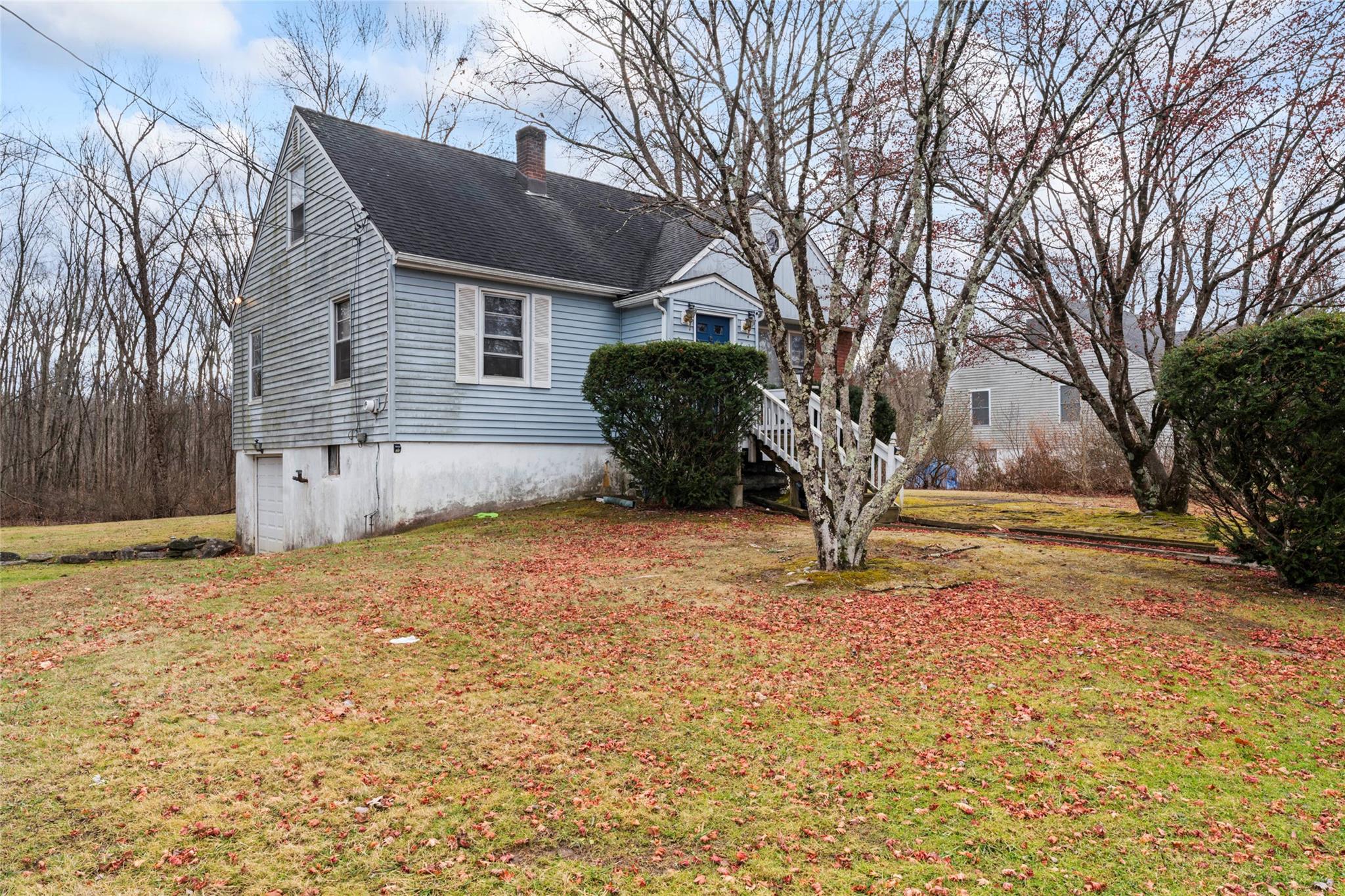 View of property exterior with a yard