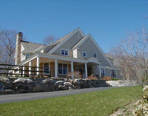 a front view of a house with a garden and patio