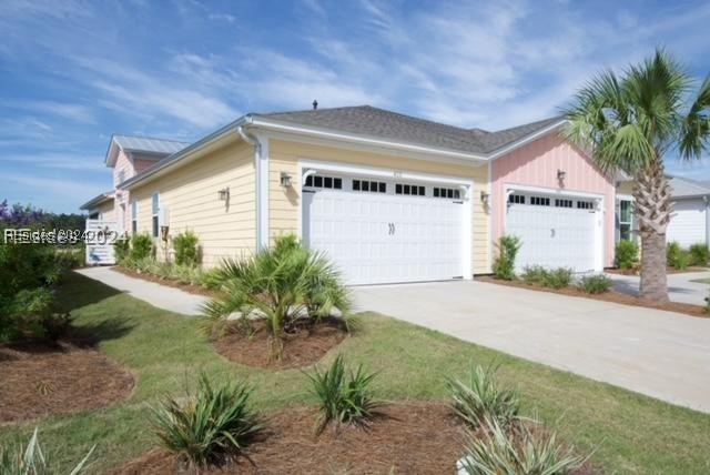 View of side of property with a garage