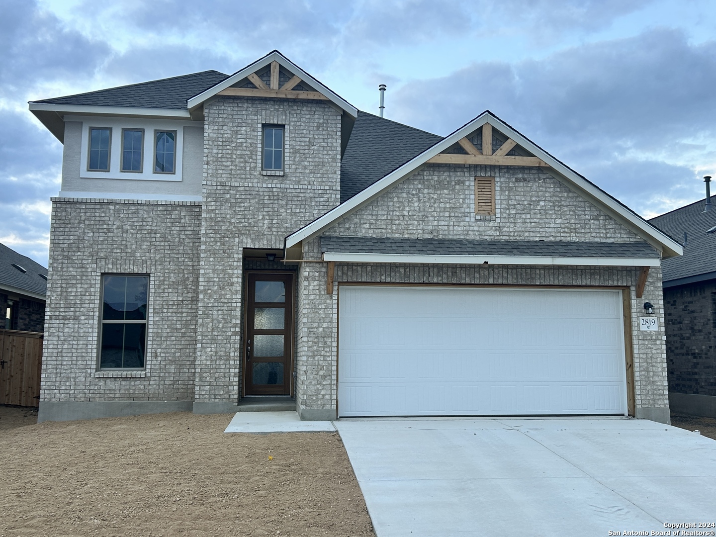 a front view of a house with garage