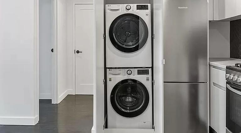 a view of a storage and utility room with washer and dryer