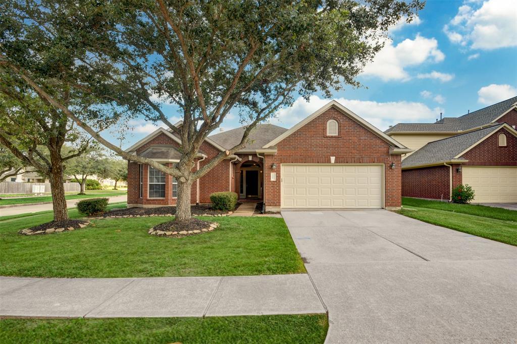 This charming brick home features a well-maintained lawn with mature trees, a two-car garage, and a welcoming front entry. Located on a quiet street, it offers great curb appeal and a spacious driveway.