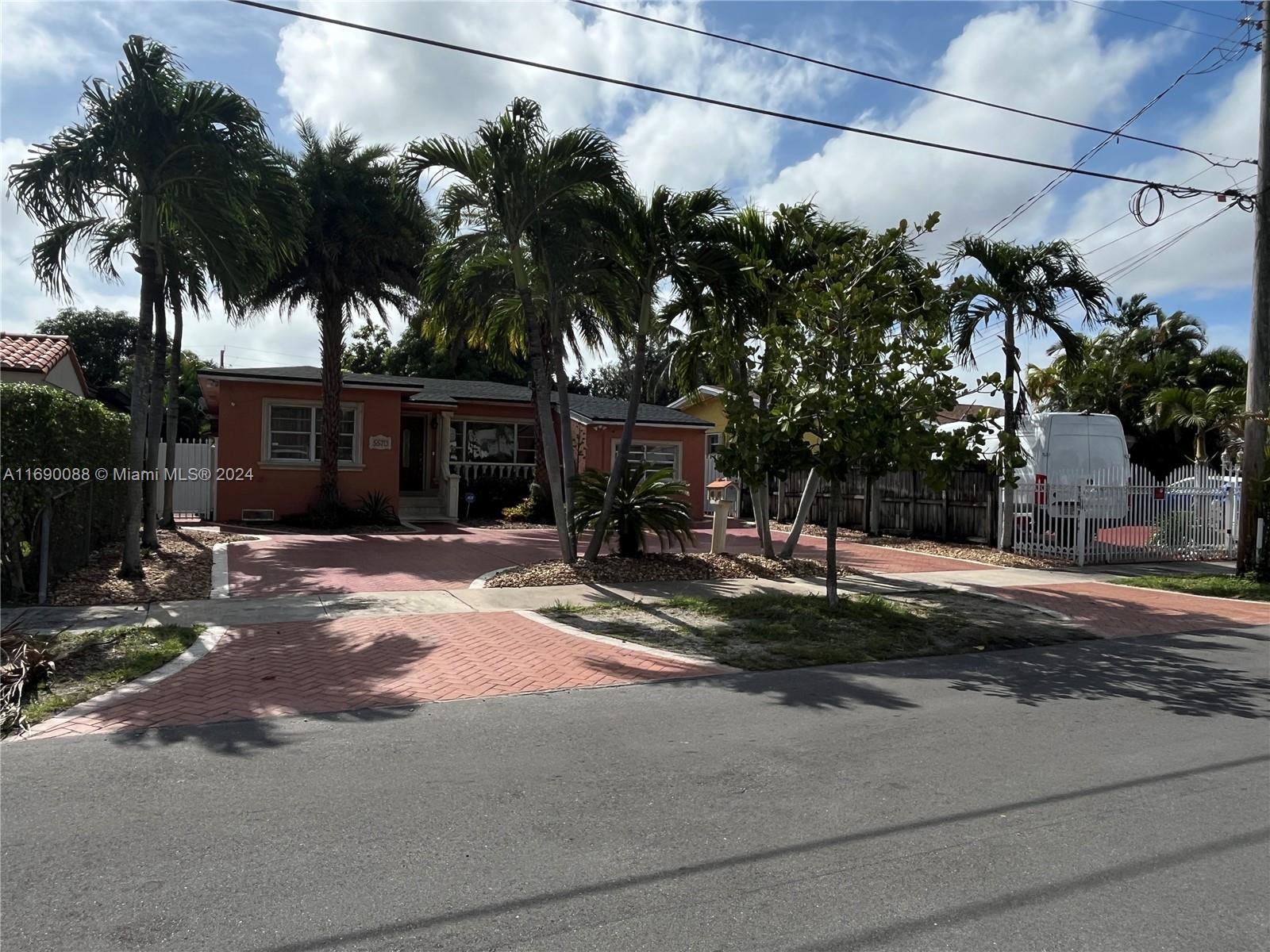 a view of a house with a patio and a yard