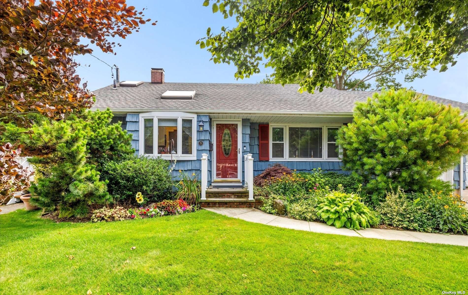 a front view of a house with a garden