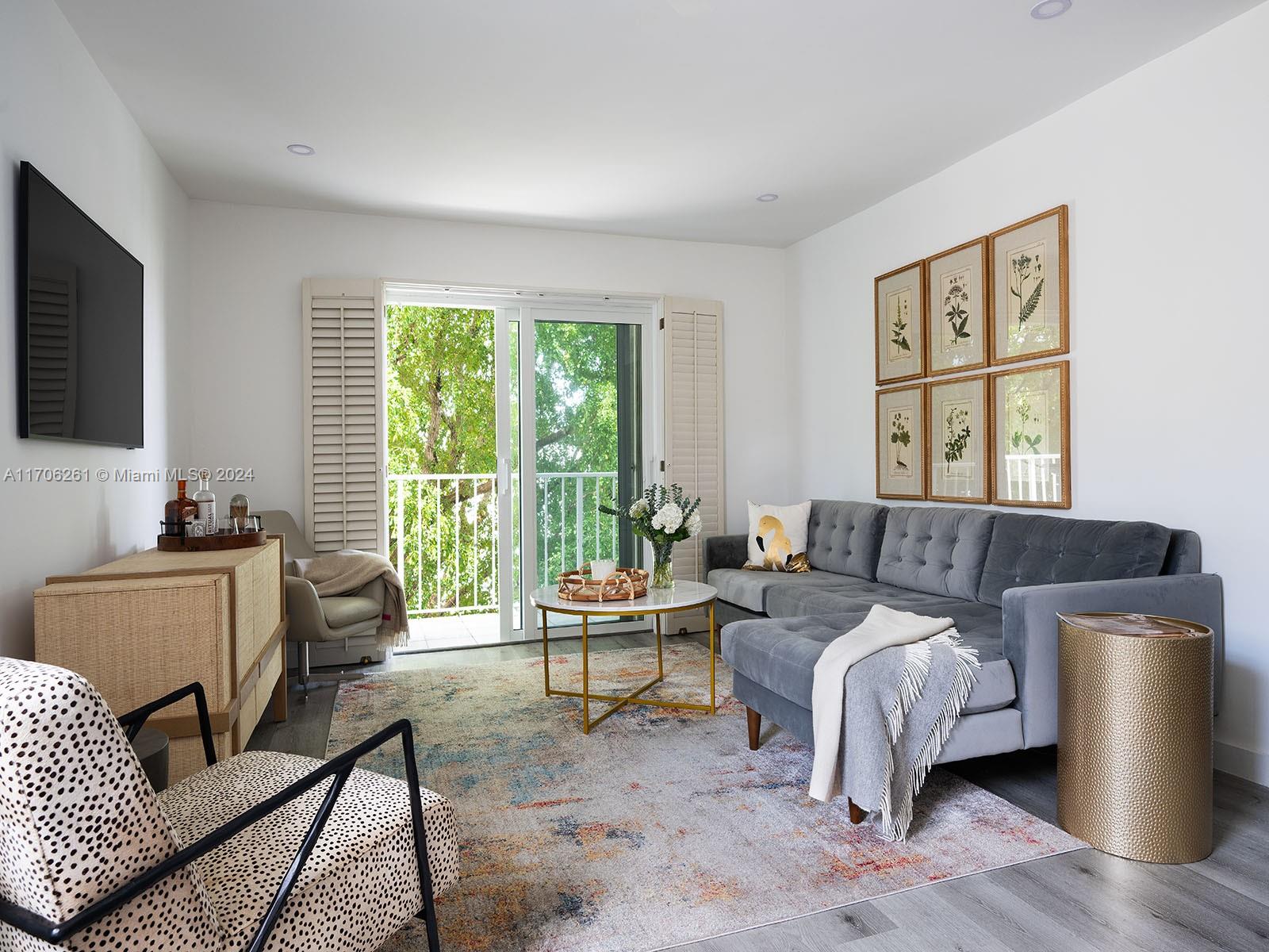 a bedroom with furniture and a large window