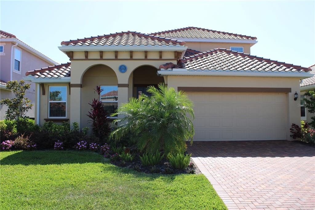 a front view of a house with garden