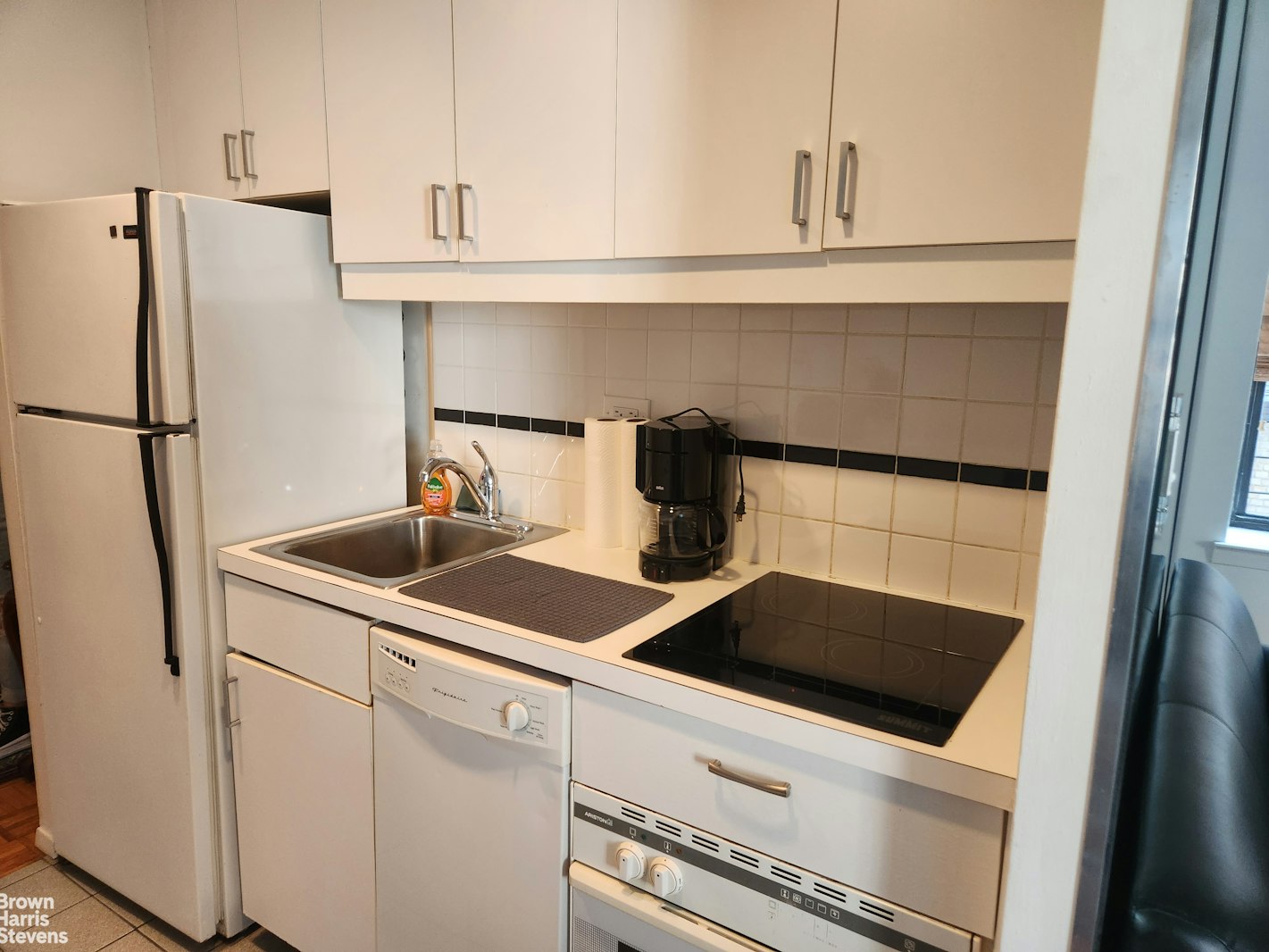 a kitchen with a refrigerator and a sink