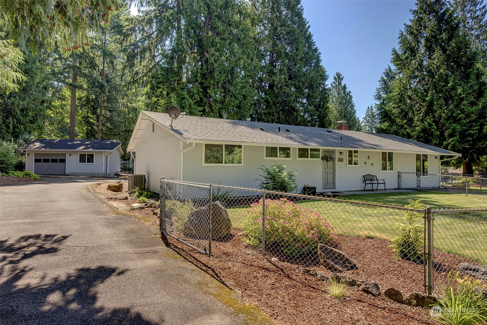 a view of a house with backyard and sitting area