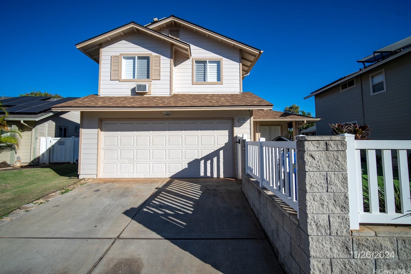 a front view of a house with garage