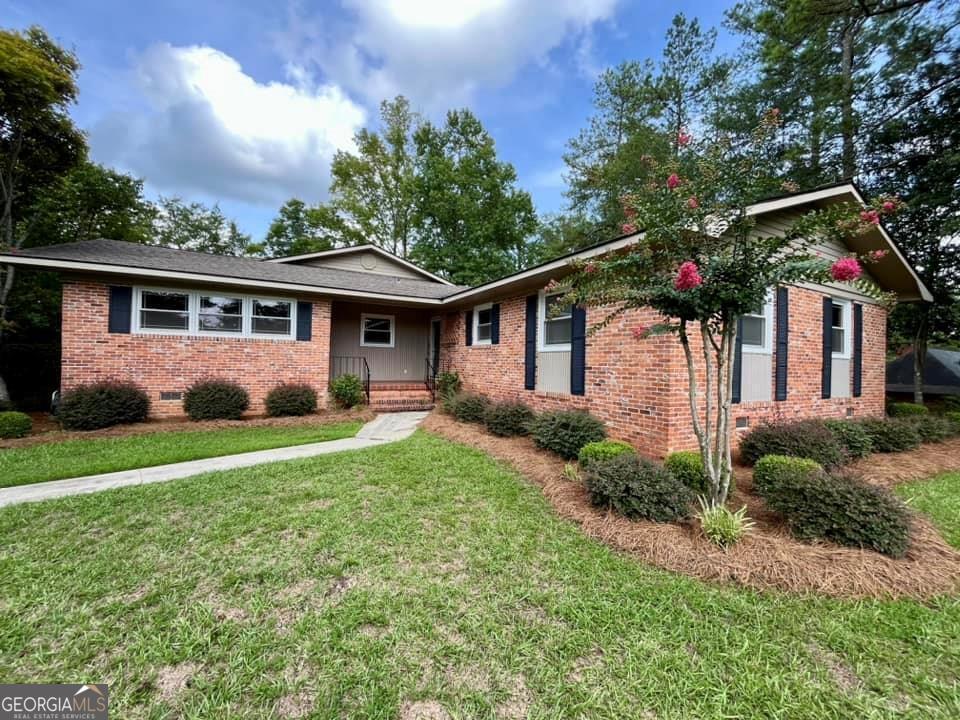 a front view of house with yard and green space