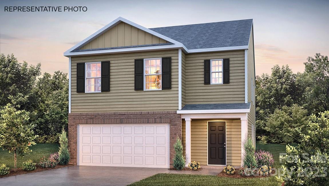 a front view of a house with yard garage and garage