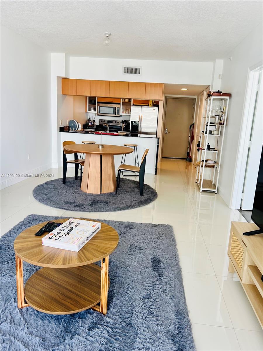 a room with furniture a rug and a flat screen tv