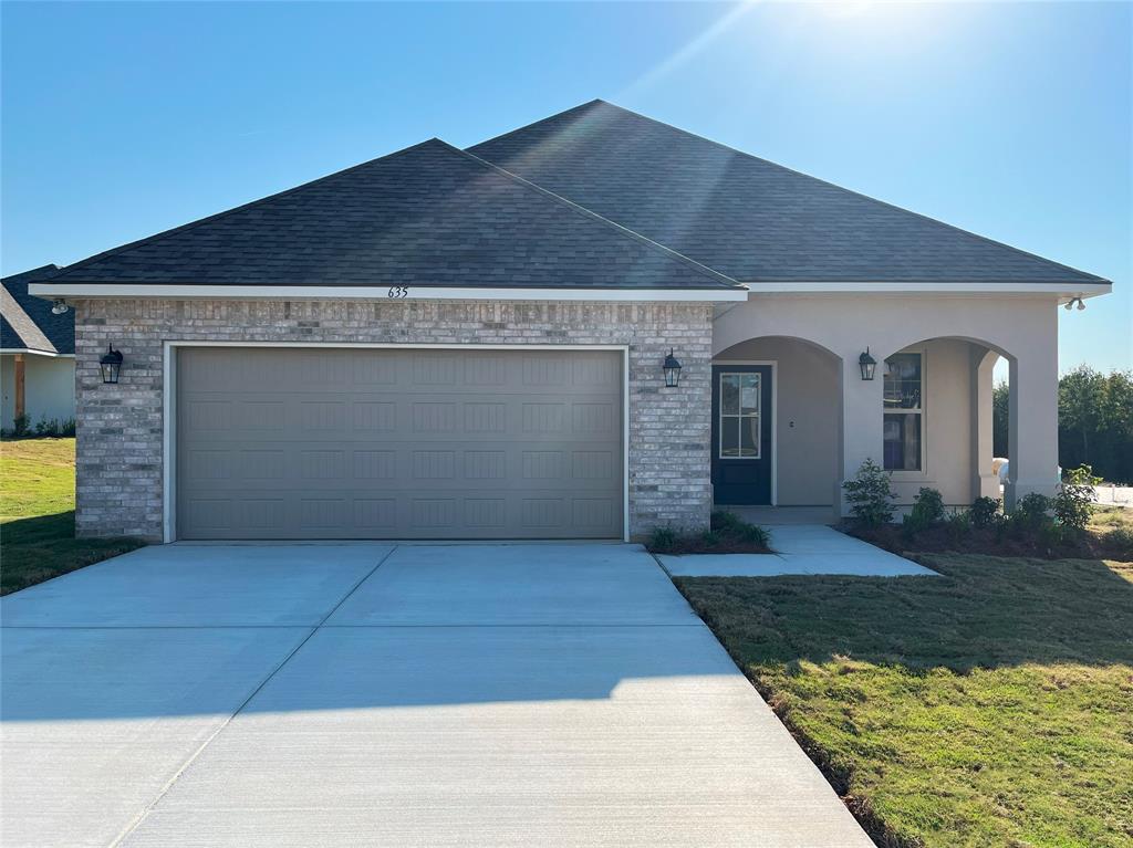 a front view of a house with yard