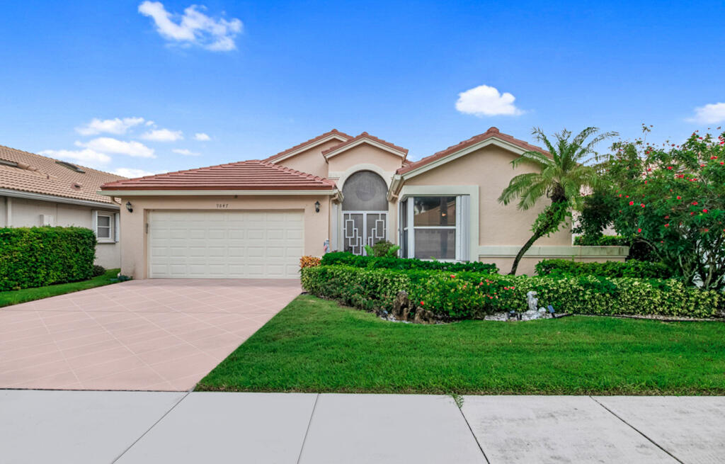 a front view of a house with a garden