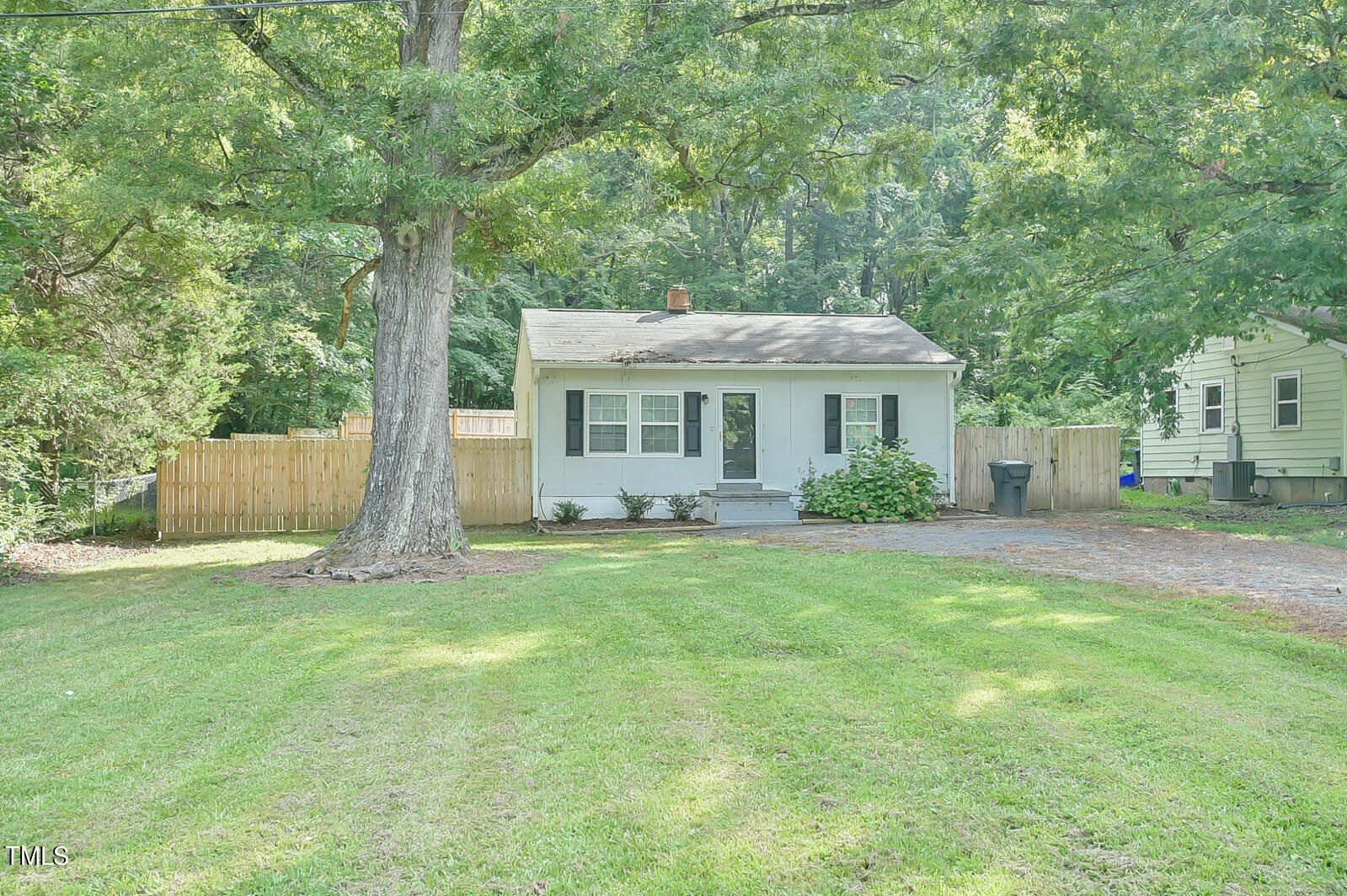 a front view of a house with a garden and yard