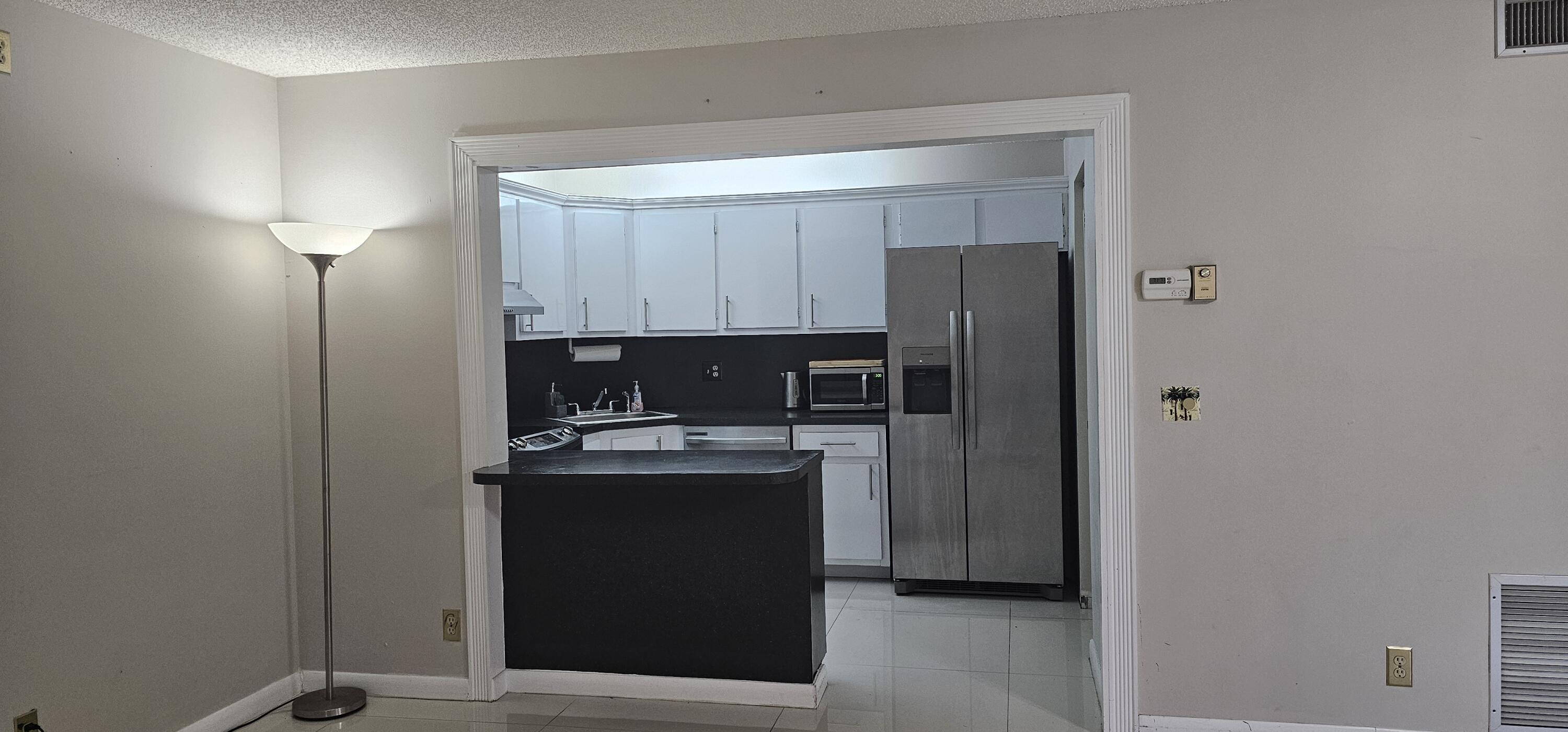 a kitchen with stainless steel appliances granite countertop a refrigerator and a stove top oven