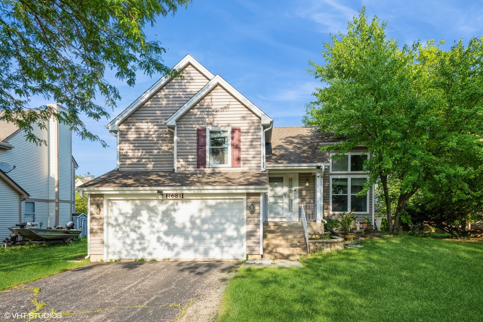 a front view of house with yard and green space