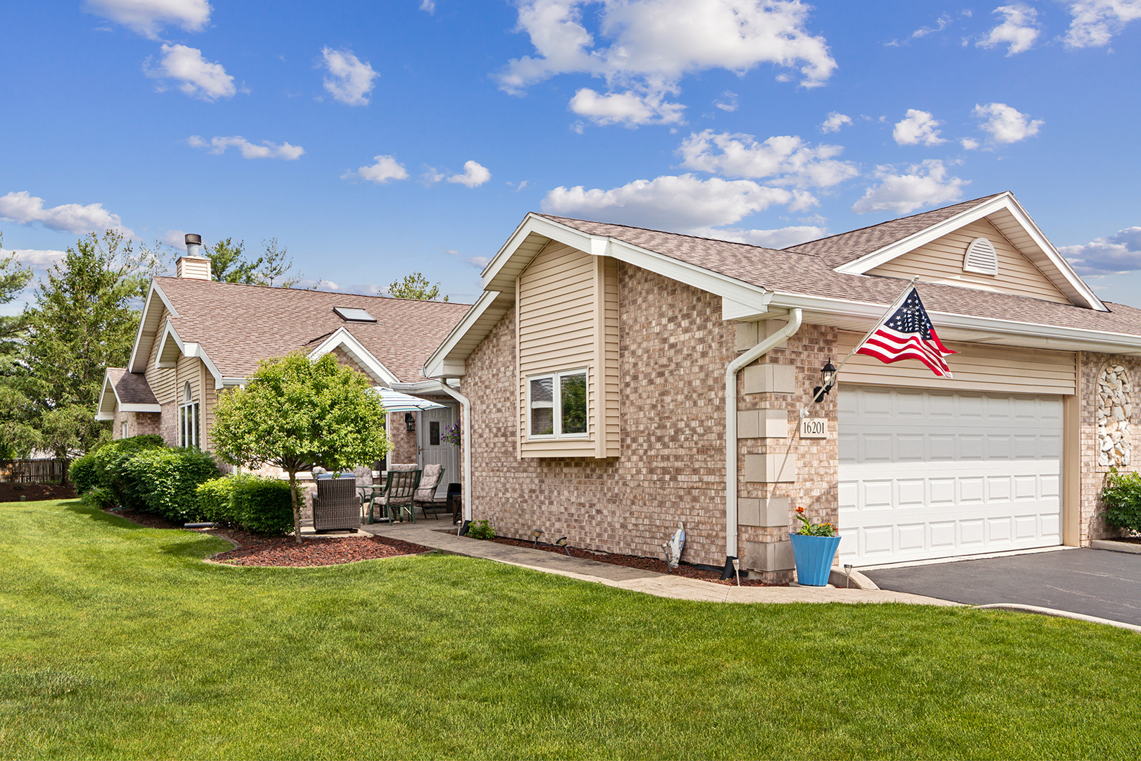 a front view of house with yard and outdoor seating