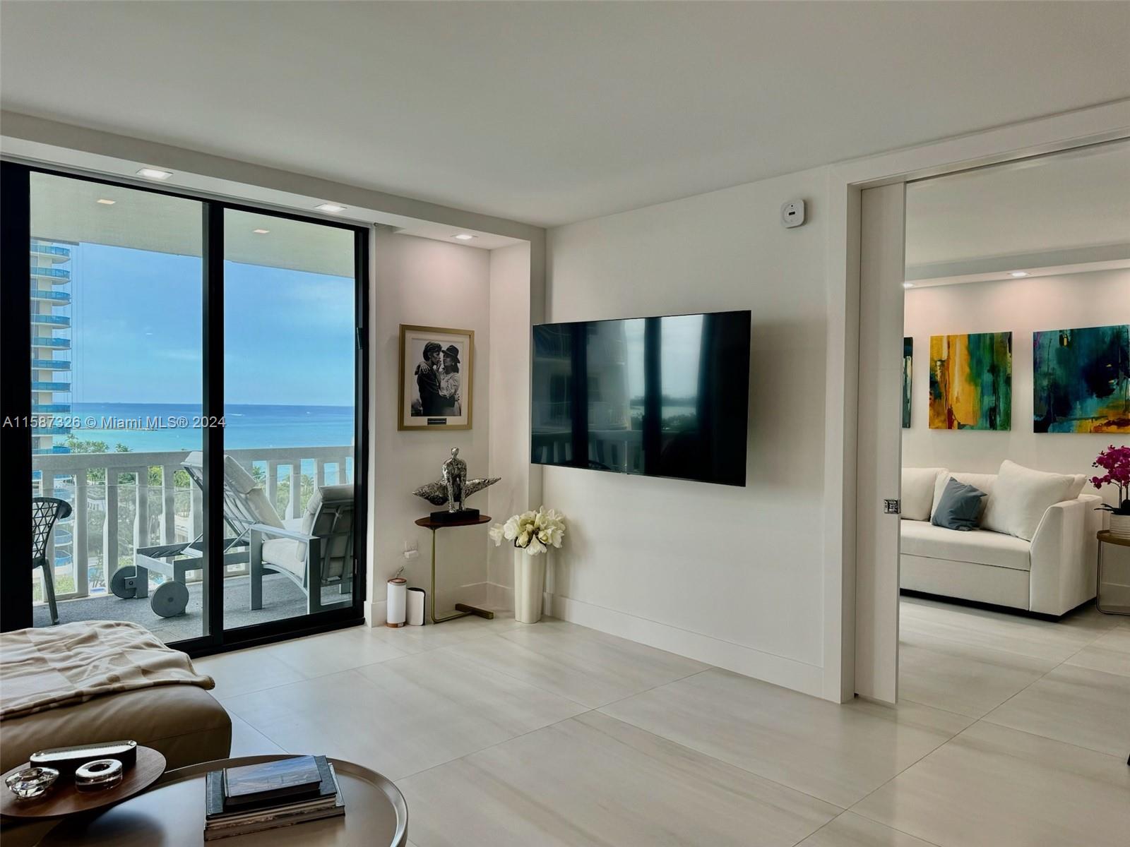 a view of living room with furniture and large window