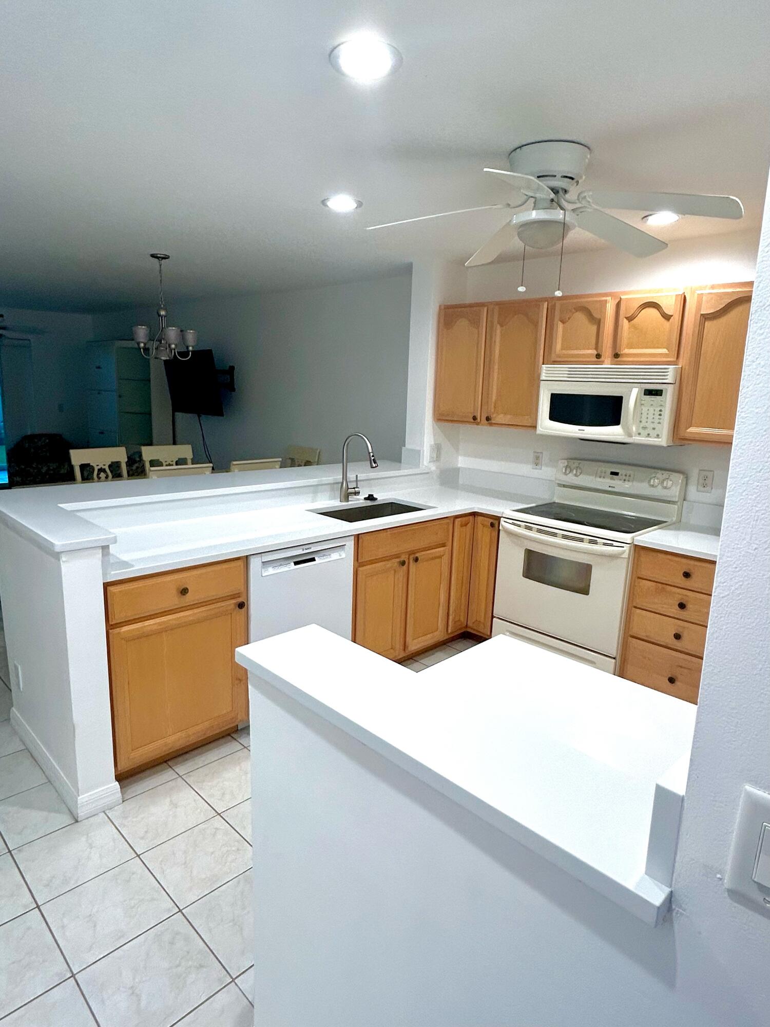 a kitchen with a sink a stove top oven and cabinets