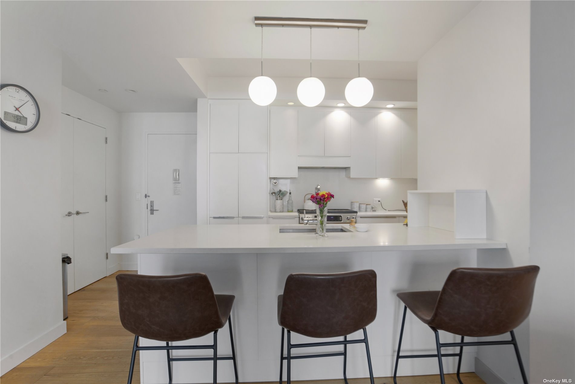 a kitchen with cabinets and chandelier