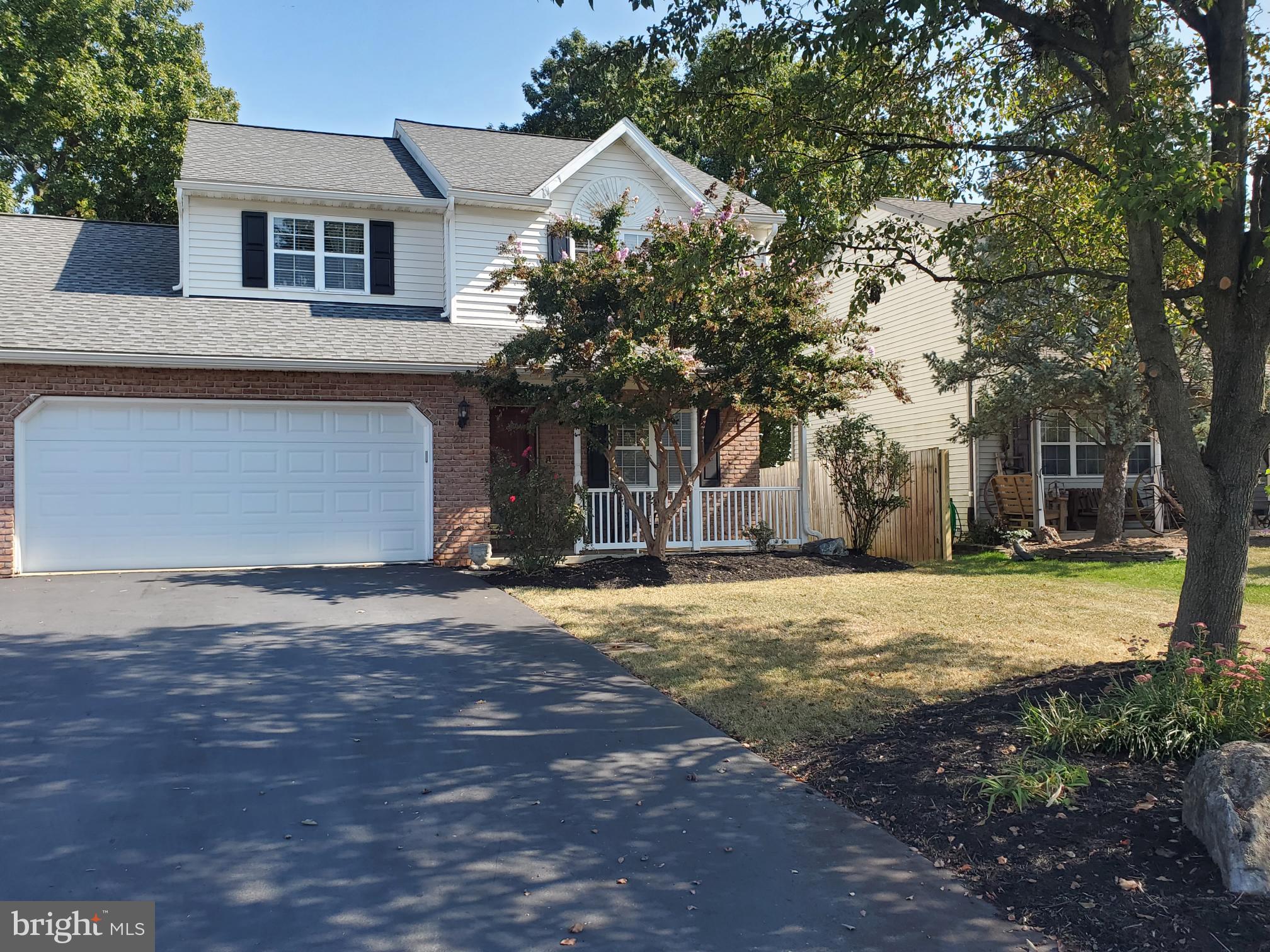 a front view of house with yard and trees