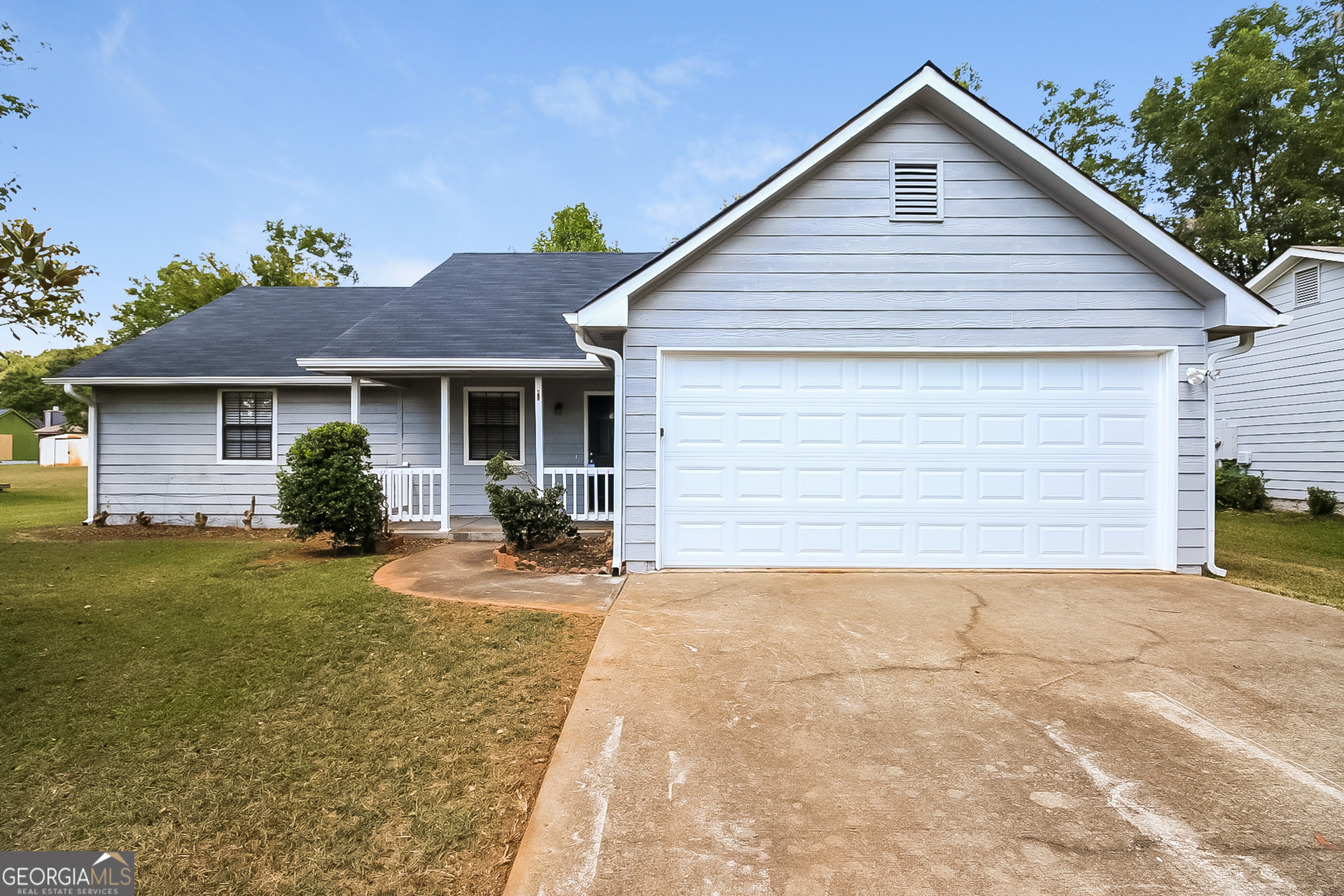 a view of a house with a yard and garage