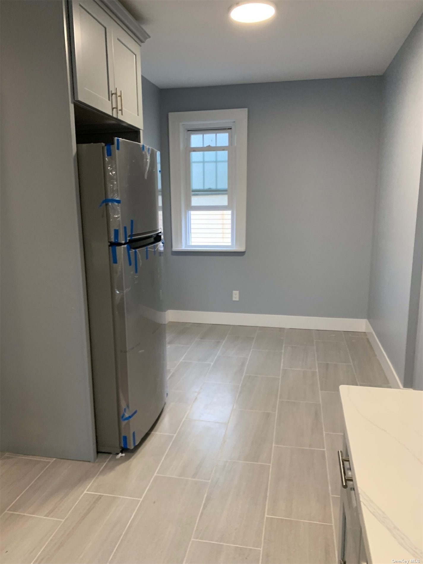 a view of a storage & utility room with closet window