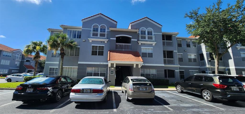 a front view of a house with cars parked