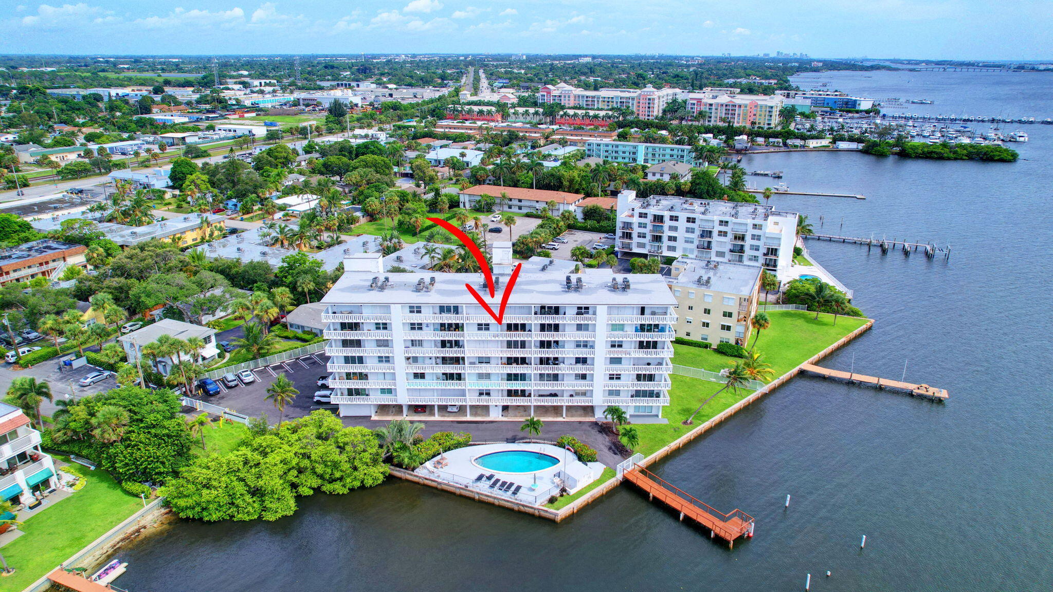 an aerial view of a house with a garden and lake view