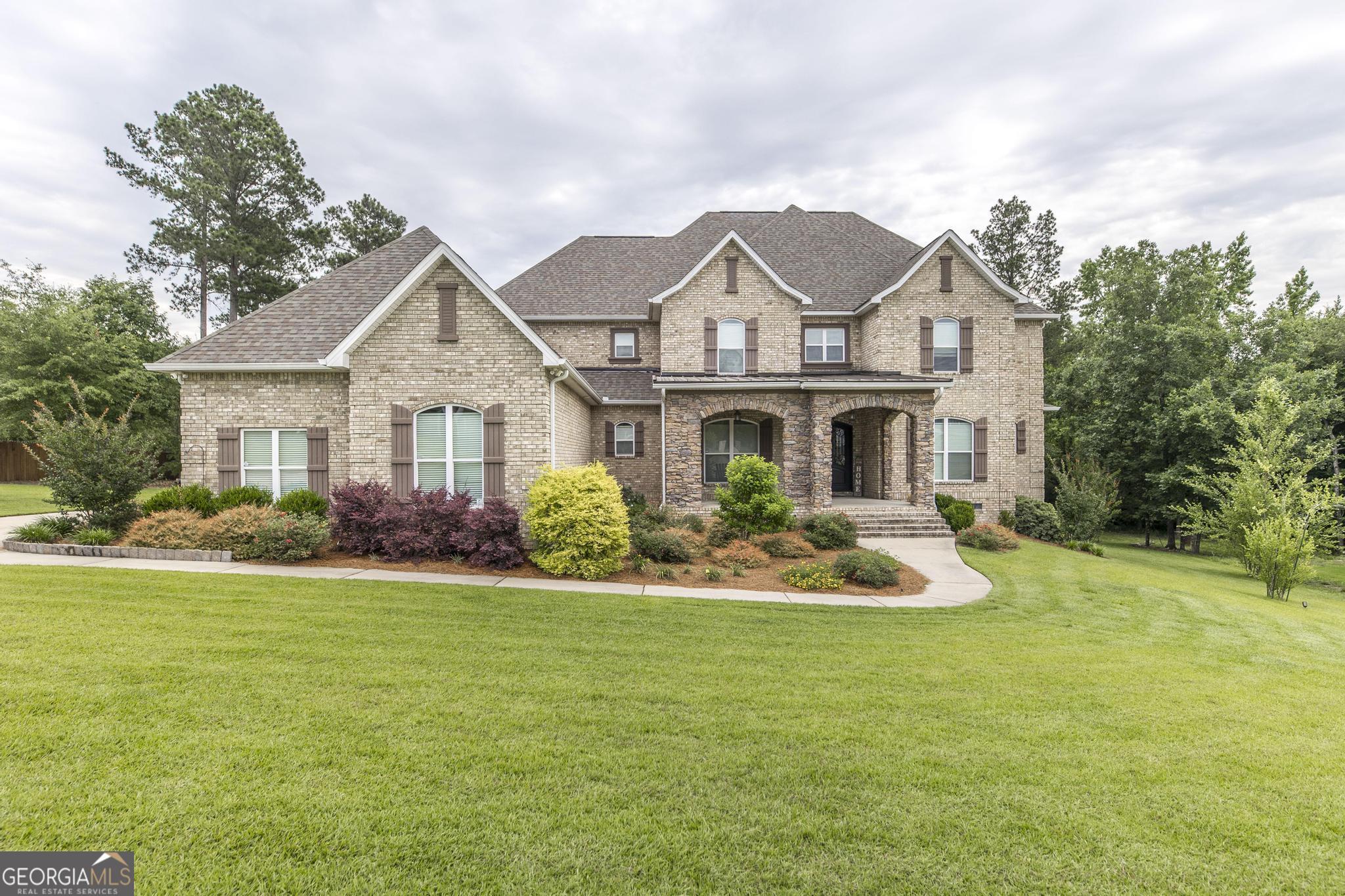 a front view of a house with garden