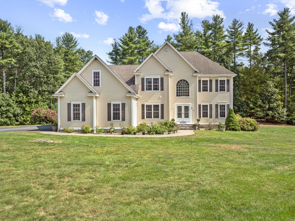 a front view of a house with a garden