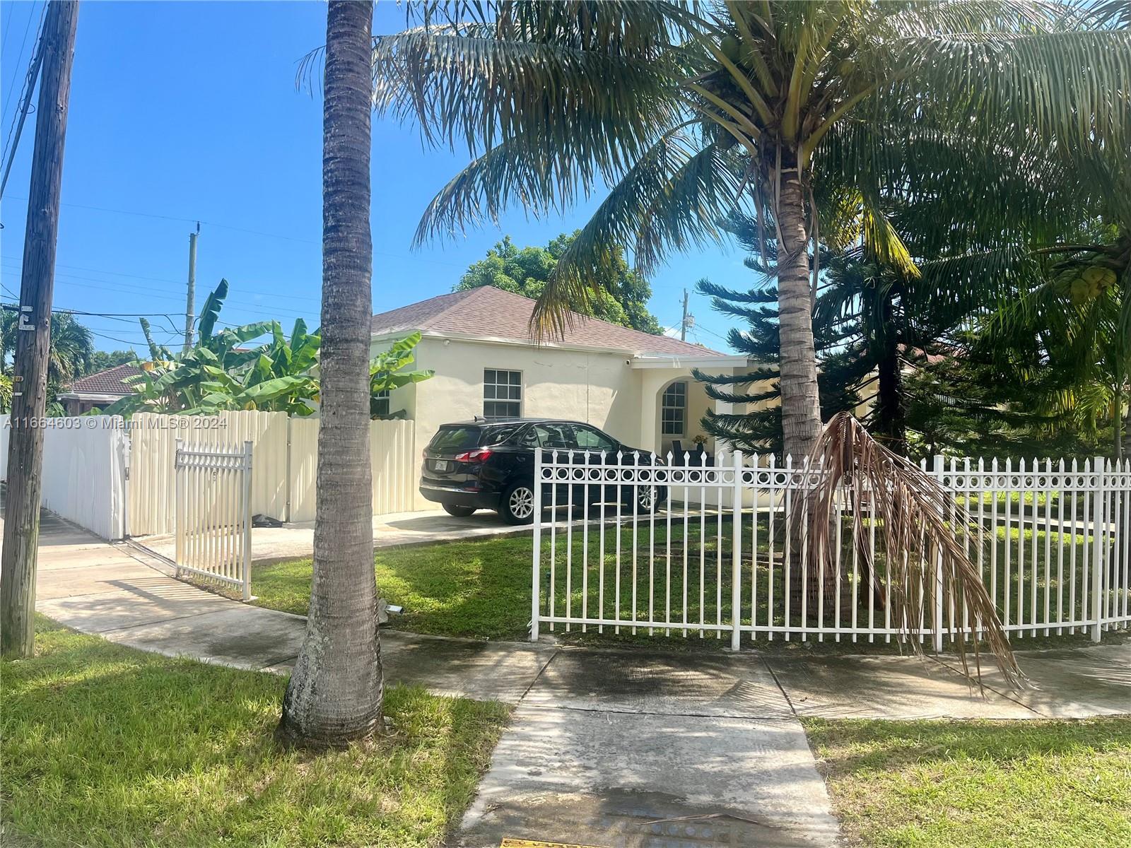 a view of a house with a wooden fence