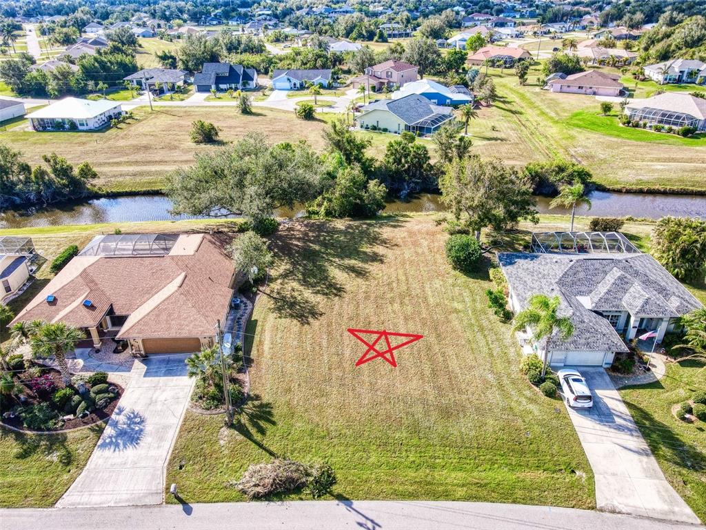 an aerial view of residential houses with outdoor space and swimming pool