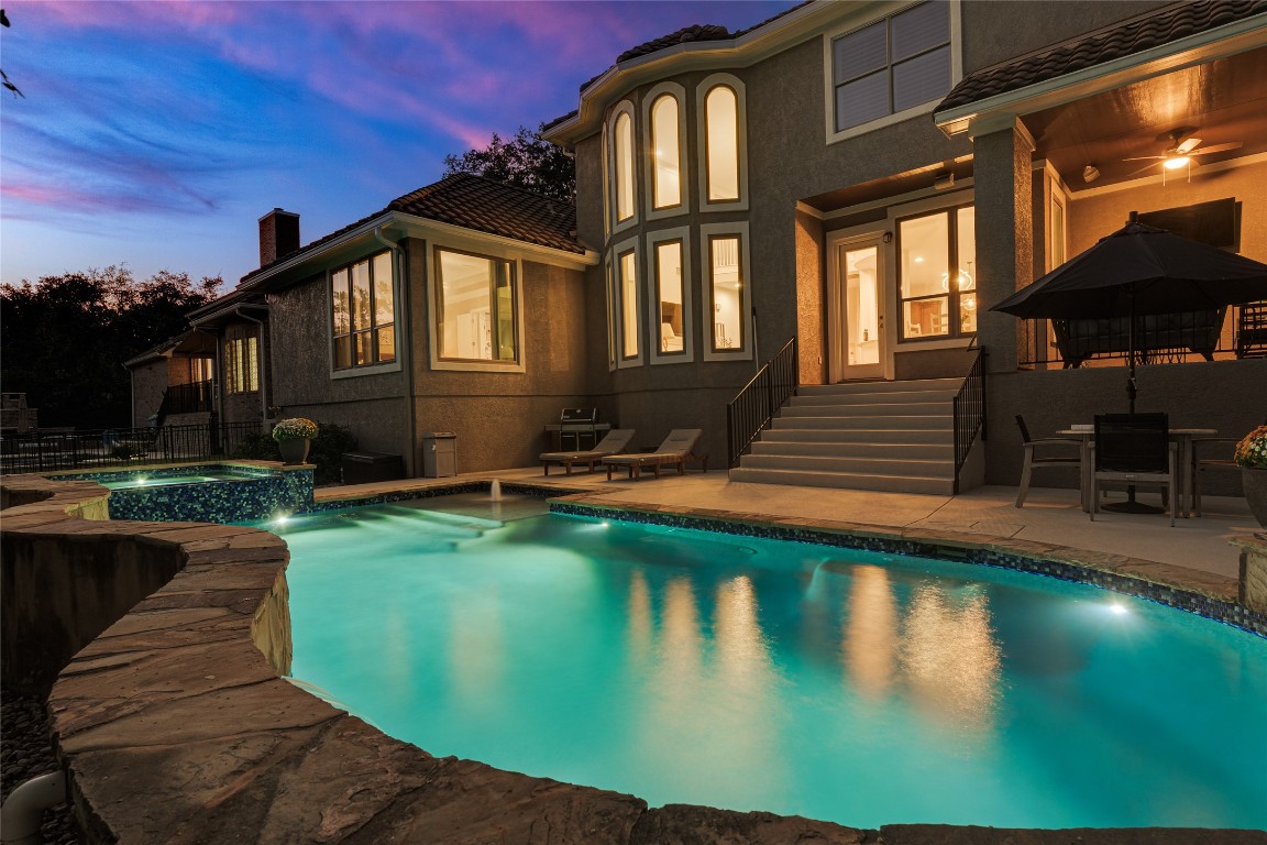 a front view of a house with swimming pool having outdoor seating