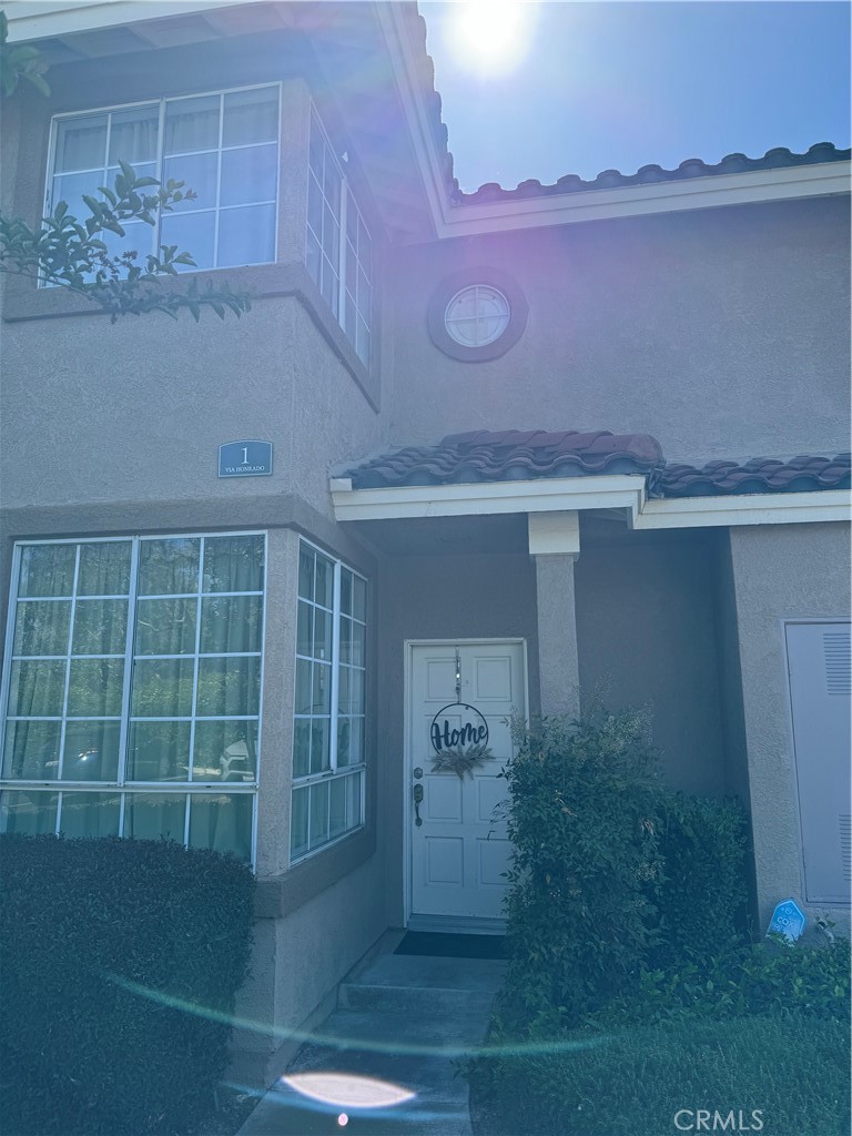 a view of a house with a porch and a potted plant