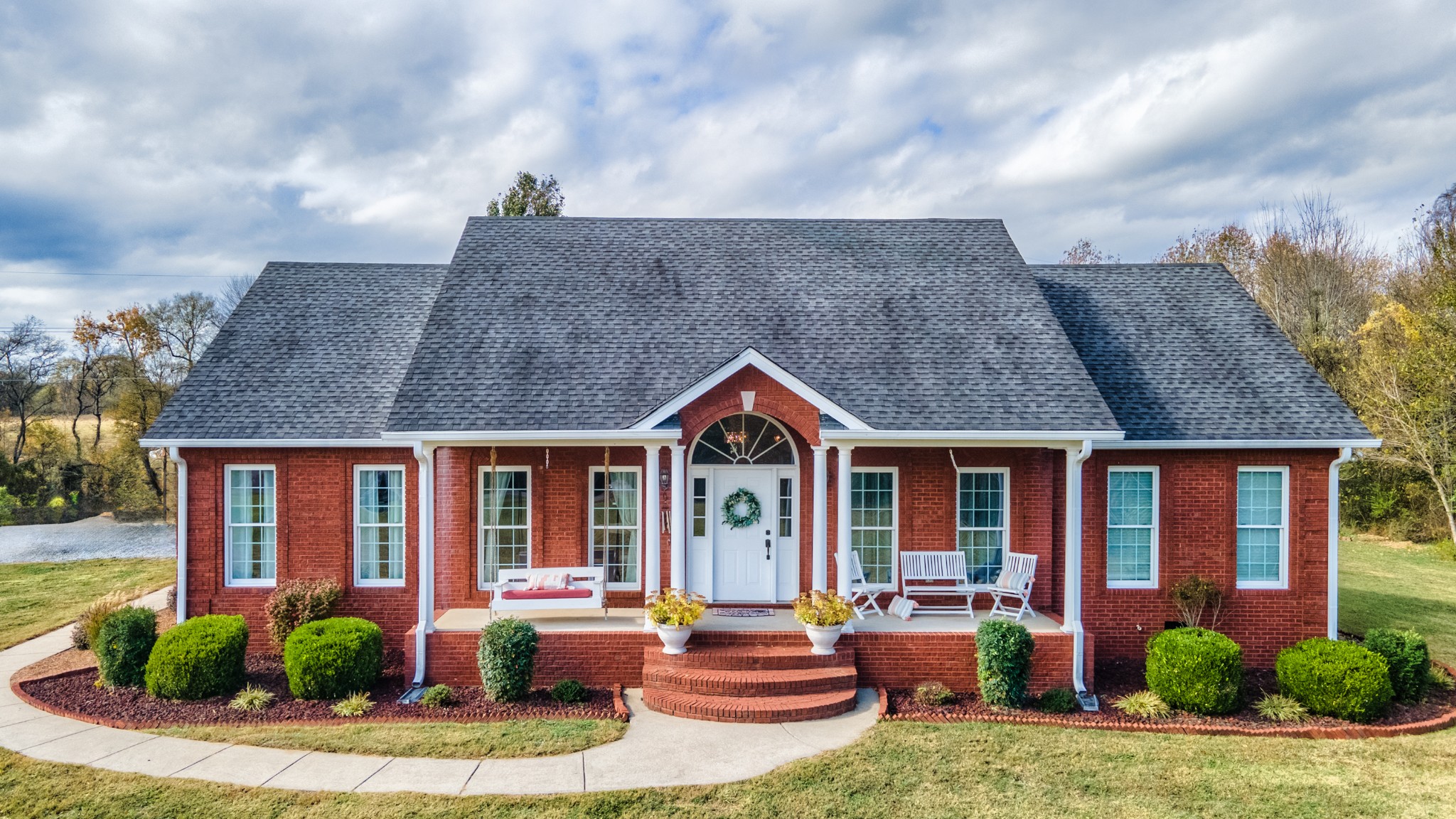 a front view of house with yard and outdoor seating