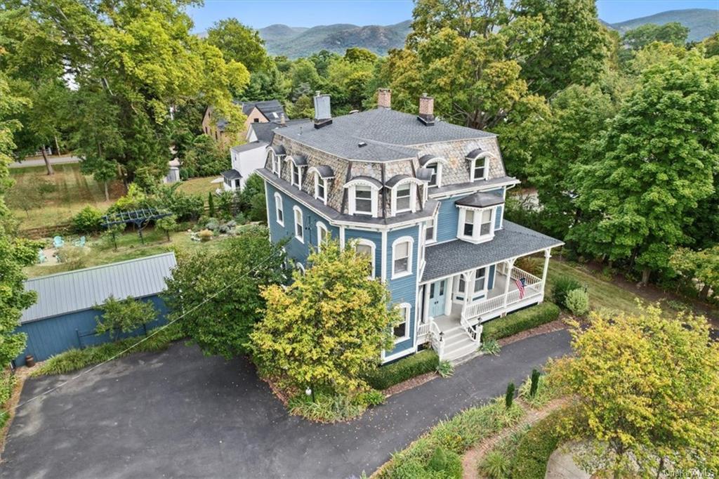 an aerial view of a house with a garden and trees