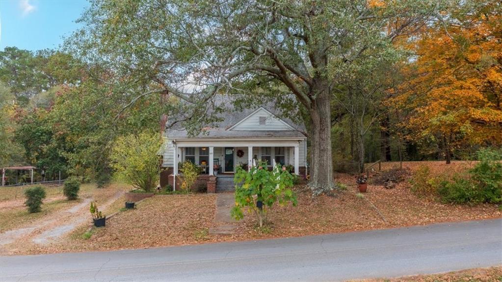 a view of a house with a tree in front